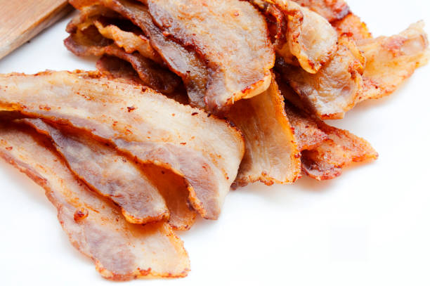 istock Fried pork bacon and wooden spatula on a white background 862023366
