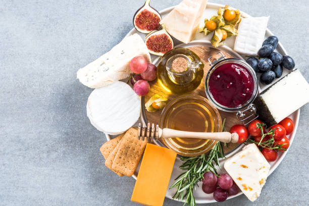 Cheese platter with all kinds of cheese and fruits Cheese platter with all kinds of cheese and fruits. plate fig blue cheese cheese stock pictures, royalty-free photos & images