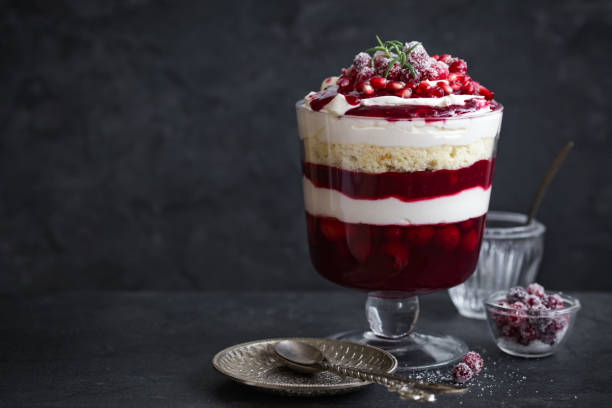 Trifle. Festive layered dessert in glass. Trifle. Festive layered dessert in glass. Dark background, selective focus, copy space trifle stock pictures, royalty-free photos & images