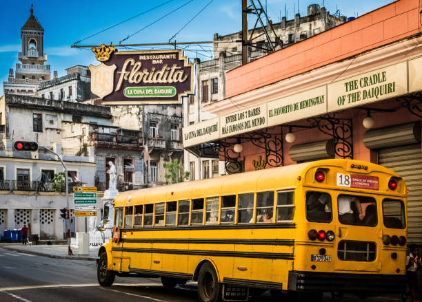 HDR - Street life view with a bus on the the street and architecture view of the Floridita bar building, which was Ernest Hemingway favorite bar in Havana City Cuba - Serie Cuba Reportage stock photo