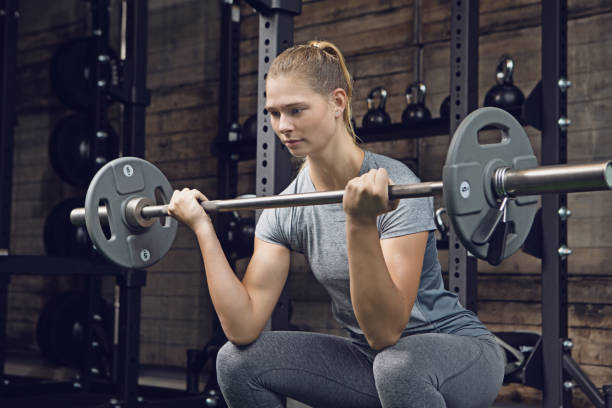 istock Beautiful Young Female Athlete using weights in Gym Setting 862048998