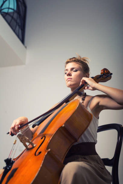 istock Female musician playing violoncello on the stage 862052170