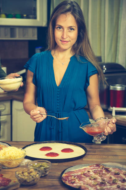 istock Happy girl preparing pizza. 862054046