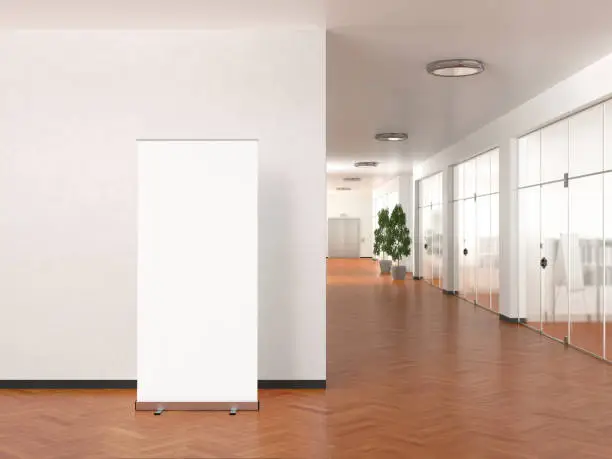 Photo of Blank roll up banner stand in modern office