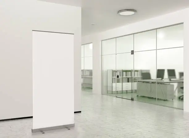 Photo of Blank roll up banner stand in modern office