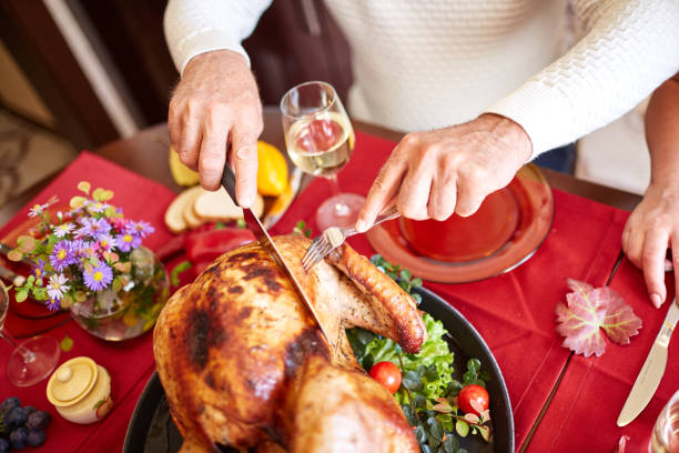 istock Close-up old man serving roasted turkey on a table background. Thanksgiving dinner. Traditional festive food concept. 862055438