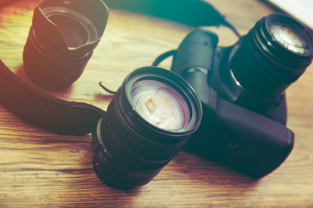 istock camera and lens on the wooden table 862058306