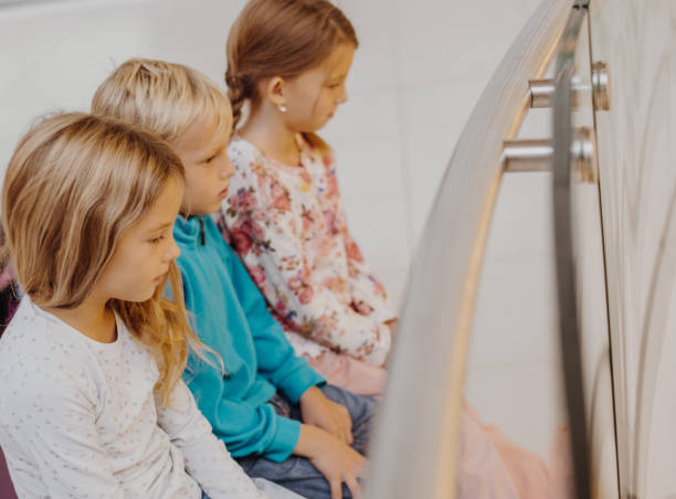 istock Triplets waiting parents in the shopping mall 862070056