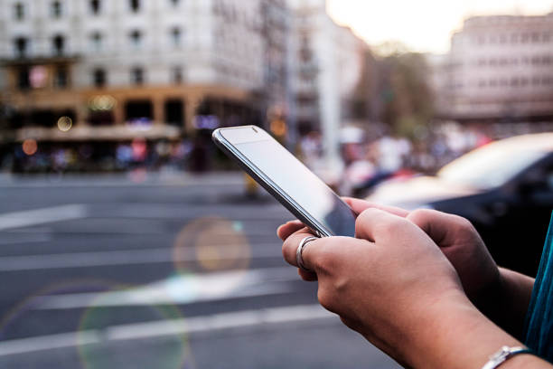 Woman using smartphone woman using smartphone. Young girl using a touchscreen smartphone and texting. Electronic device in the hands of hipster girl who is posting tweets by using mobile application. city of mobile stock pictures, royalty-free photos & images