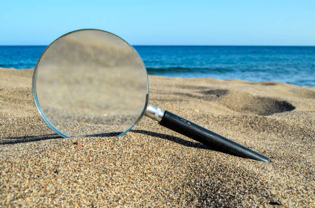 istock Magnify Glass on the Sand Beach 862073436