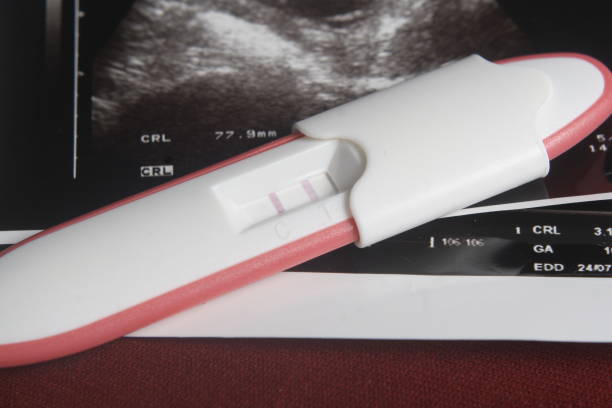istock Close Up, Pregnancy Test Pack, Positive Result At Dark Red Background 862073658