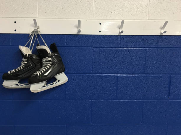 istock Hockey skates hanging on locker room 862083346