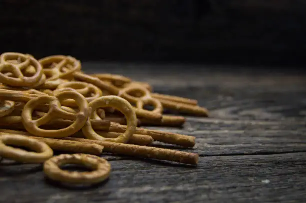 Pretzel and pretzel sticks on wooden table