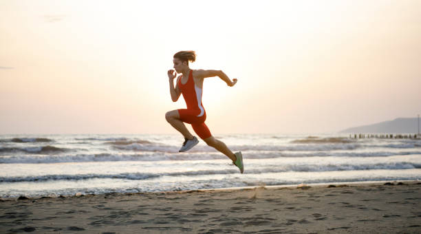 Youn Man Running At Beach Athlete exercising pentathlon stock pictures, royalty-free photos & images