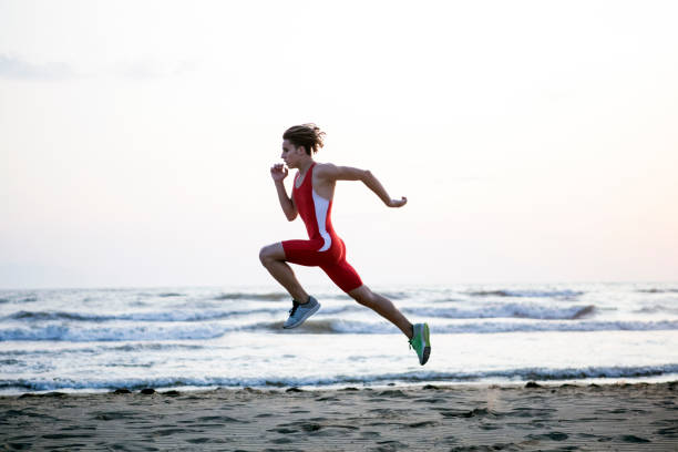 Youn Man Running At Beach Athlete exercising pentathlon stock pictures, royalty-free photos & images
