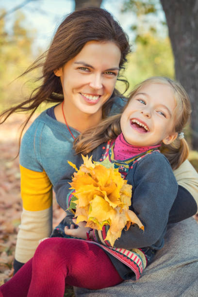 istock Mother and daughter playing in autumn park 862097176