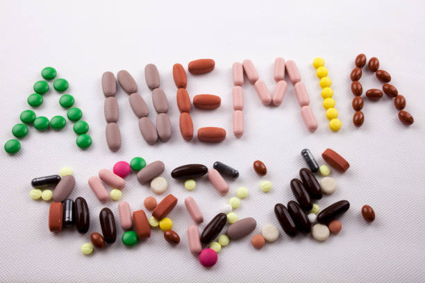 Hand writing Medical care concept written with pills drugs capsule word ANEMIA On white isolated background with copy space Hand writing Medical care concept written with pills drugs capsule word ANEMIA On white isolated background with space man writing on white board stock pictures, royalty-free photos & images