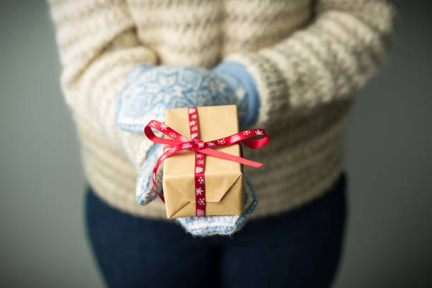 istock A girl holding a box with a Christmas present 862098054