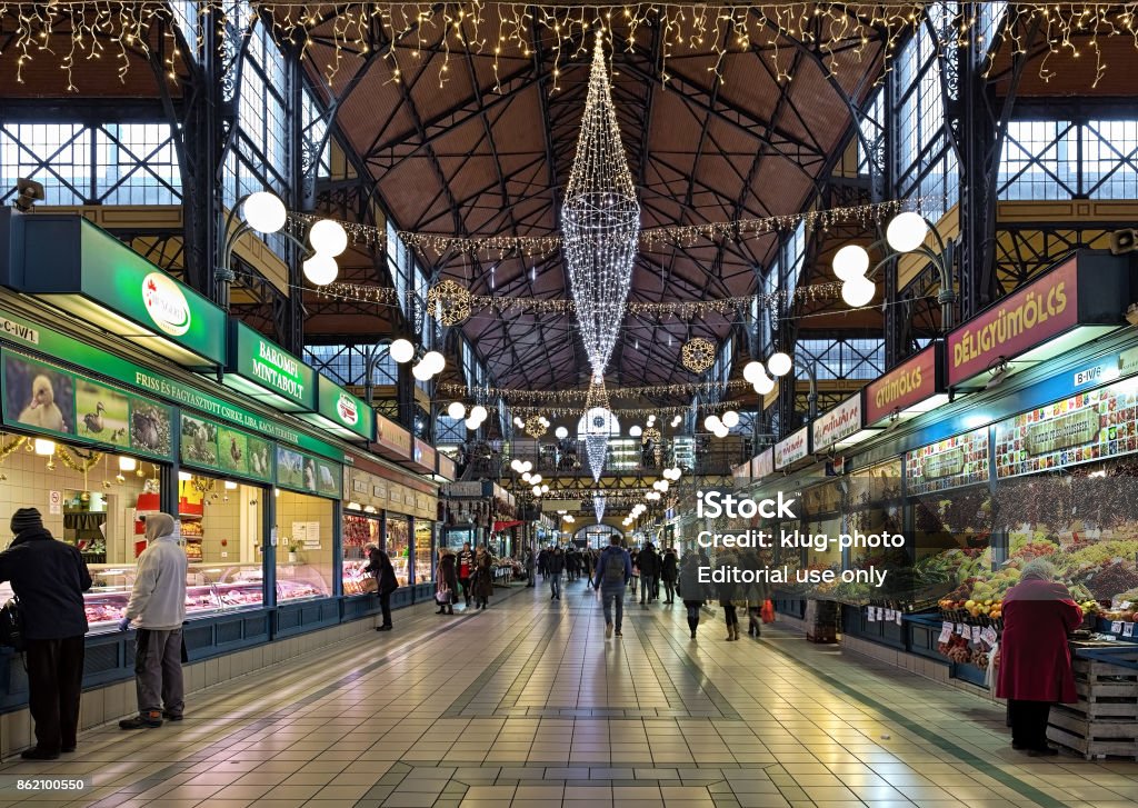 Interior of the Great Market Hall in Budapest decorated for Christmas, Hungary Budapest, Hungary - December 7, 2016: Interior of the Great Market Hall (or Central Market Hall) decorated for Christmas. Unknown people walk around the market hall and buy food. The Great Market Hall is a largest and oldest indoor market in Budapest. It was built around 1897. Budapest Stock Photo