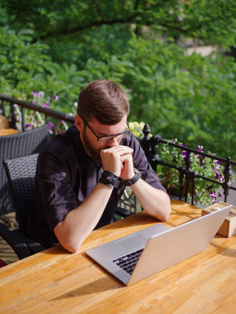 istock Goodly young man working on laptop while sitting outdoors . Business concept. 862110812