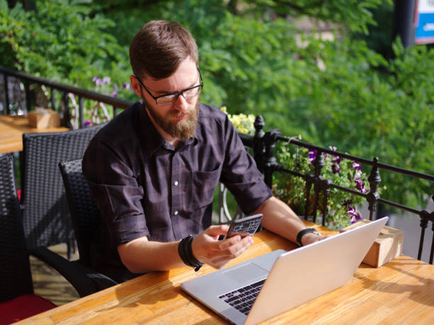 istock Goodly young man working on laptop while sitting outdoors . Business concept. 862111074