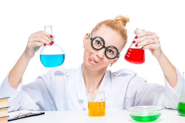 istock Cheerful and nuts lab assistant with red and blue liquid in flasks on white background 862111270
