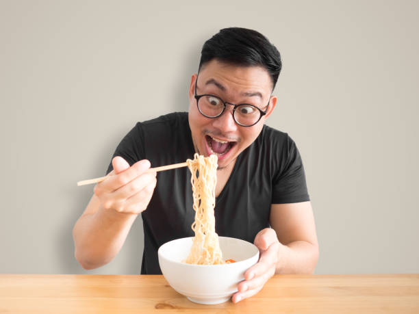 istock Funny surprised face man eatting instant noodles. 862111468