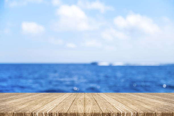 istock Empty wood plank table top with blur navy blue ocean with speed boat and bokeh light,Mock up for display or montage of product,Banner or header for advertise on social media,Summer background 862112136