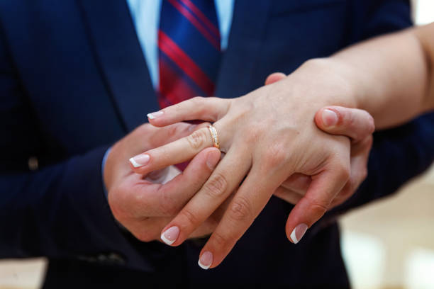 istock the groom wears a ring on the bride's 862112504