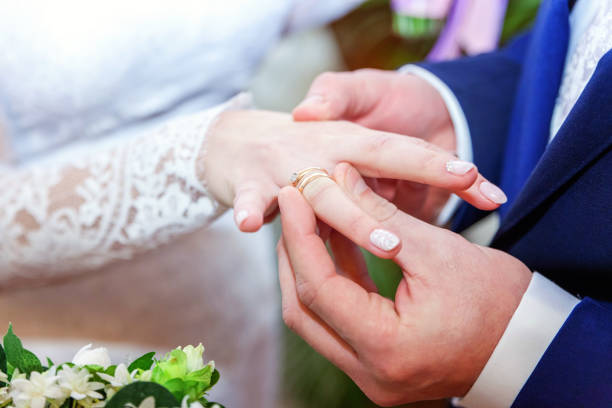 istock the groom wears a ring on the bride's 862112890