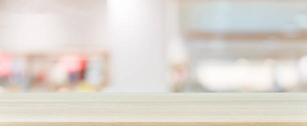 istock Wooden board empty table blurred background. Perspective brown wood table over blur in department store background, Panoramic banner - can be used mock up for montage products display or design. 862117294