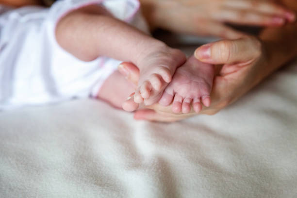 istock Baby feet and mother hands 862120114