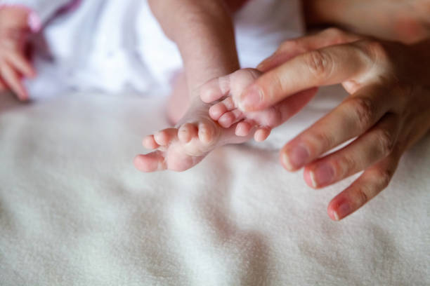 istock Baby feet and mother hands 862120154