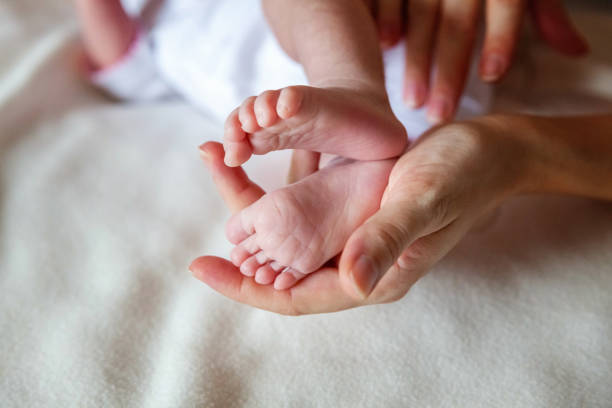 istock Baby feet and mother hands 862120324