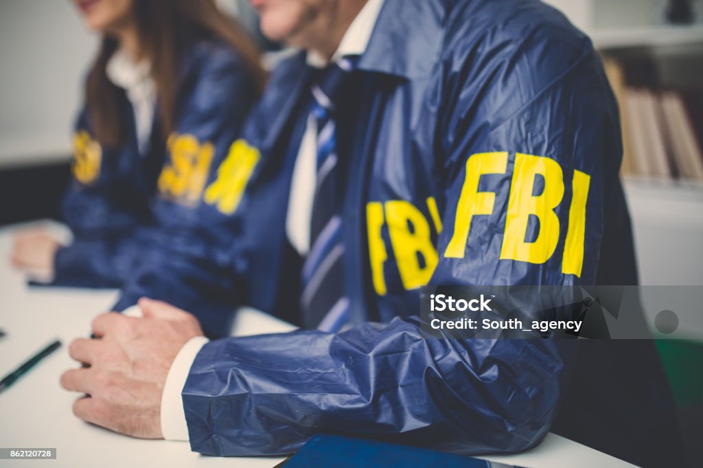 FBI team in office Two people, man and woman, working together in office, FBI team. FBI Stock Photo