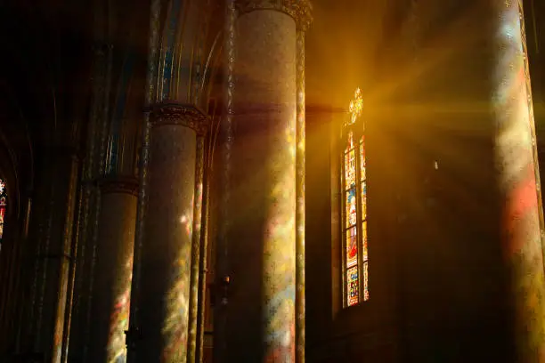 Photo of Sunlight between the columns in catholic church