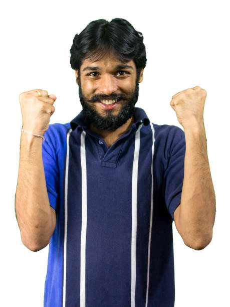 istock Happy young man celebrating with arms raised 862139314