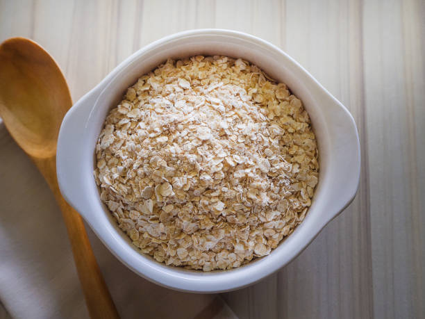 istock The oats rice in white bowl on top table wood worm tone image 862139724