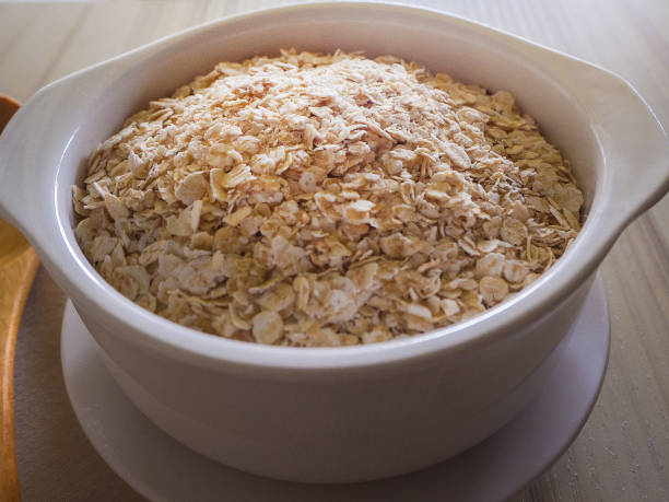 istock The oats rice in white bowl on top table wood worm tone image 862139780