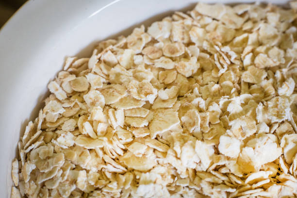 istock The oats rice in white bowl on top table wood worm tone image 862139988