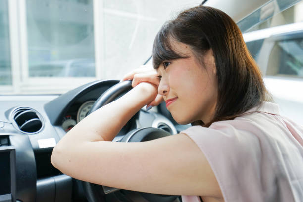istock Young woman sleeping in car 862142318