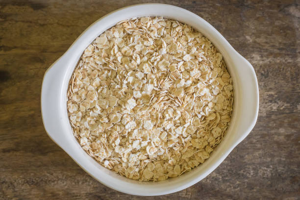 istock The oats rice in white bowl on top table wood worm tone image 862142382