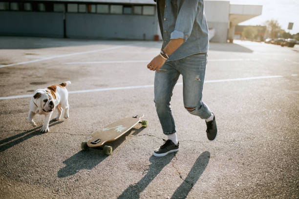 istock Men Skateboarding with bulldog puppy 862143116