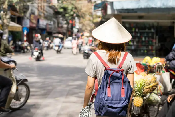 Young traveler with backpack at old quarter in Hanoi, Vietnam