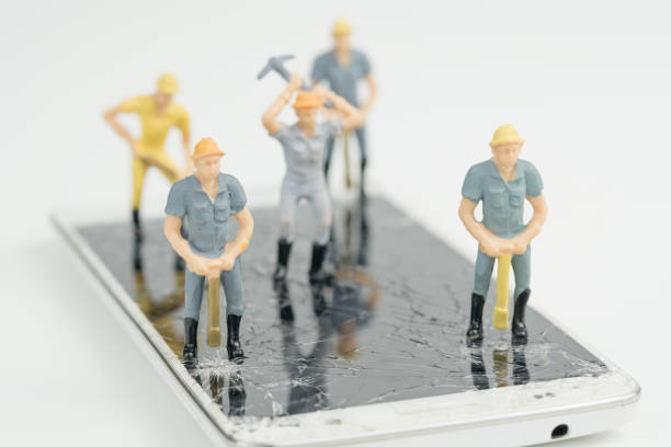 Electronic board with miniature figure worker man at repair and work