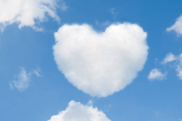 istock blue sky with hearts shape clouds. Valentine's holiday background. Vector 862157818