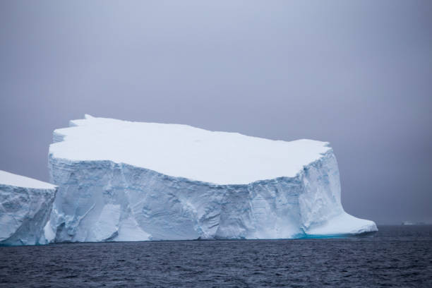 istock Tabular iceberg set against dark skies 862160436
