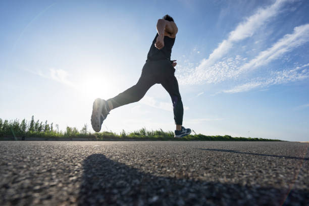 istock young male runner running on asphalt road against sky 862161212
