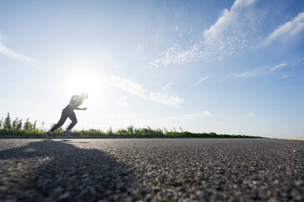 istock young male runner running on asphalt road against sky 862161268