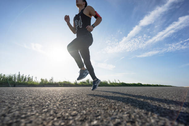 istock young male runner running on asphalt road against sky 862161276